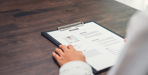 Businesswoman submits resume employer to review job application information on the desk, presents the ability for the company to agree with the position of the job.