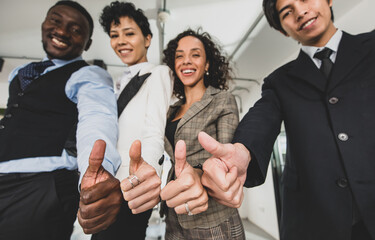 Selective focus on face and smile. Businessmen and businesswomen Ethnic diversity, thumbs up, showing excellence and teamwork to work successfully. Concept teamwork success.