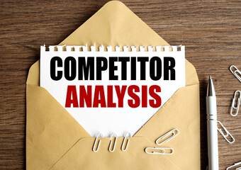 competitor analysis. Text on white paper. on paper in an envelope on a wooden table.