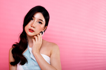 Portrait of Asian girl wear pink dress over pink tone background