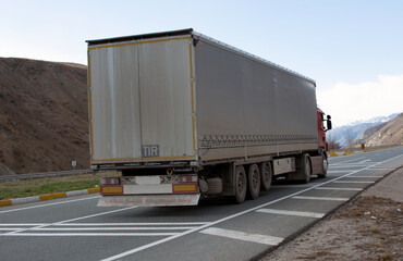 Truck moves on the road at speed, delivery of goods .Transport in Europe. Dirty truck on the road. Cargo transportation.