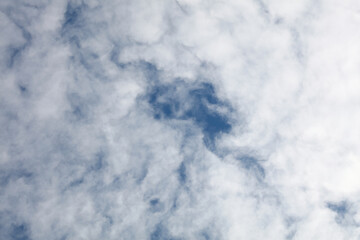 Bright white clouds over blue sky