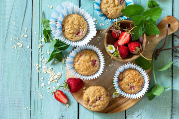 Healthy homemade cakes, summer dessert. Gluten free strawberry oatmeal muffins and fresh...