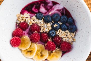 Healthy fruit bowl with oat blueberries, raspberries, yougurt and banana