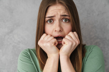 Close up of a scared shocked blonde young woman