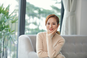 Fototapeta premium Relaxed calm woman resting breathing fresh air feeling mental balance enjoying wellbeing at home on sofa