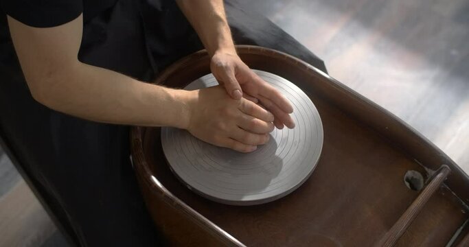 Potter puts colored clay to the potter's wheel for sculpting ceramics in nerikomi style, neriage ceramics, potter makes ceramics in slow motion, 4k 60p Prores HQ 10 bit