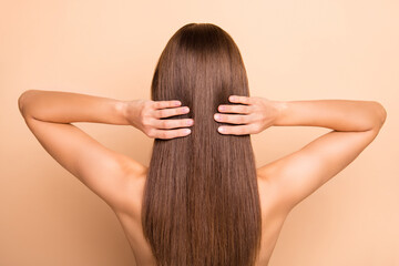 Rear photo of young person arms touch perfect healthy long hair wear nothing isolated on beige color background