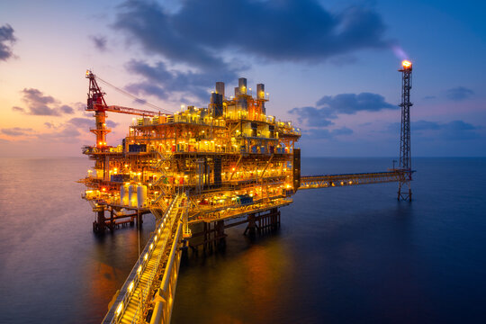 Sunset at Offshore production platform in petroleum industry