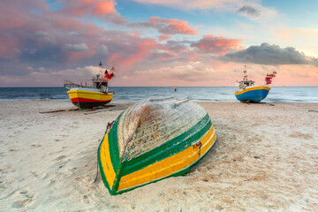 Amazing sunset with fishing boats at the beach of Baltic Sea in Sopot, Poland - obrazy, fototapety, plakaty