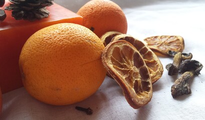 Fresh and dry oranges with dry mushrooms on the table