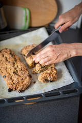 delicious crispy muffin from the oven and sliced ​​by the woman's hands