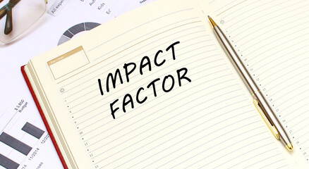 An open diary with text lies on an office desk with financial charts.