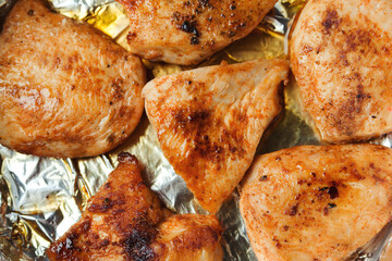 Hot baked chicken fillet in a pan, top view. Quick dinner dish recipe. Healthy homemade food.