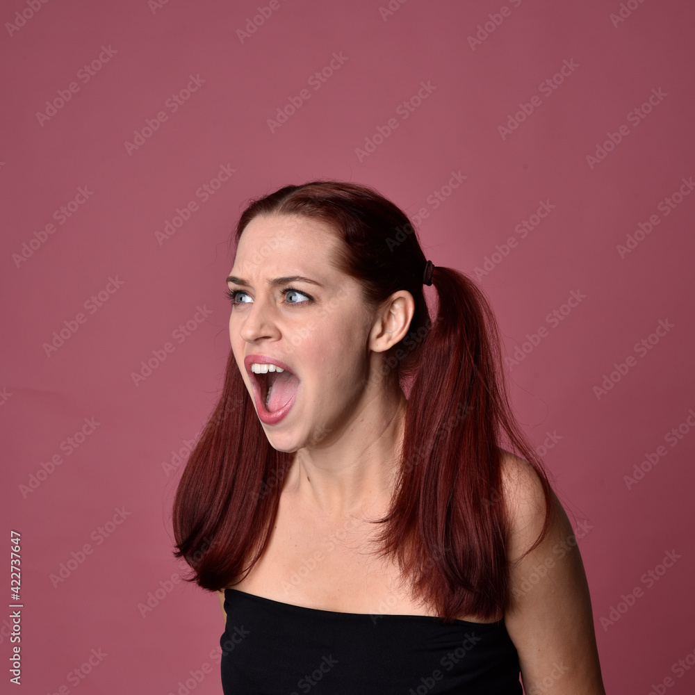 Poster close up portrait of red haired women with different facial expressions on a pink studio background.