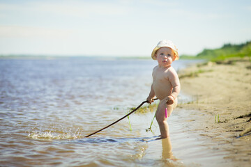 toddler playing on sandy beach, selective focus
