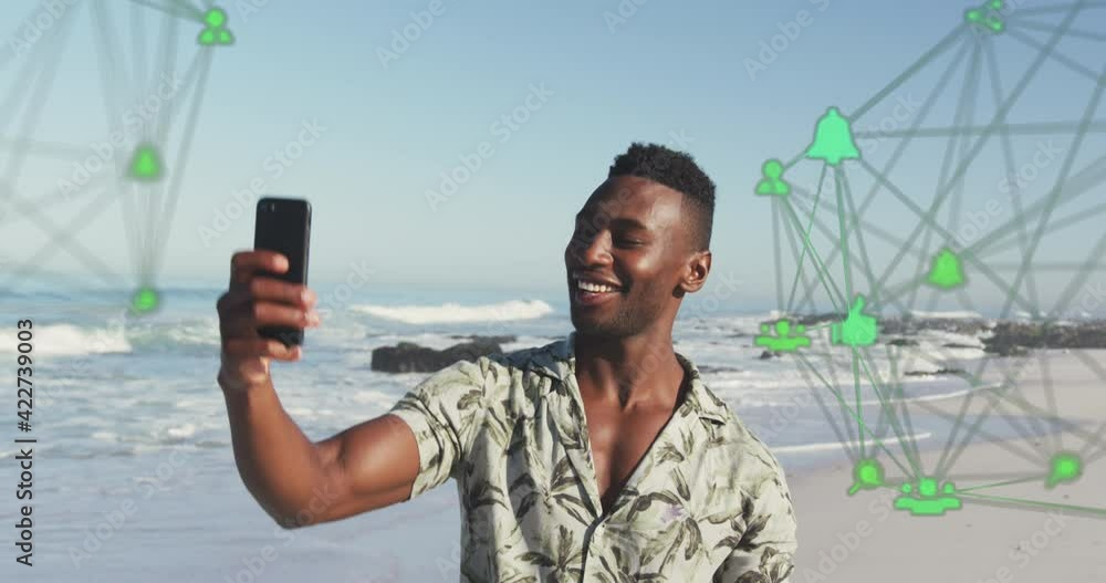 Poster animation of spinning networks with social media digital icons over man using smartphone on beach