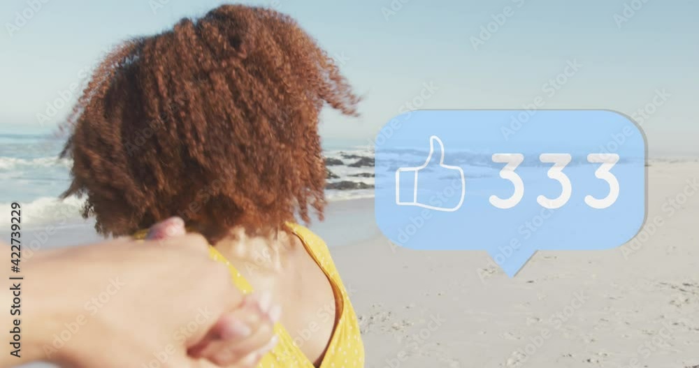 Poster animation of speech bubble with thumbs up digital icons and numbers over smiling couple on beach