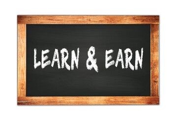 LEARN  &  EARN text written on wooden frame school blackboard.