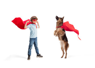 Child pretending to be a superhero with his super dog isolated on white studio background