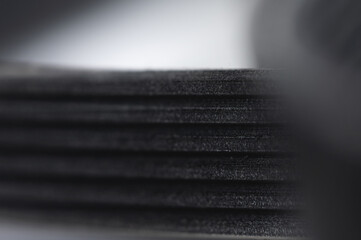 Close-up of a poly V-belt of a generator on a gray background in shallow depth of field. Background for rubber products of auto parts