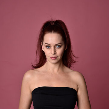 close up portrait of red haired women with different facial expressions on a pink studio background.