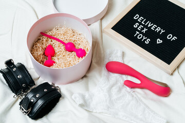 light background with different sex toys. Online shopping, shopping, delivery, the concept of Stay...