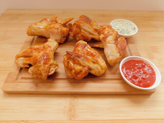 Chicken wings with dips on the wooden table