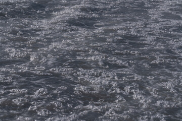 White foam on the sea as an abstract background
