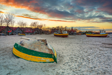 Amazing sunset with fishing boats at the beach of Baltic Sea in Sopot, Poland
