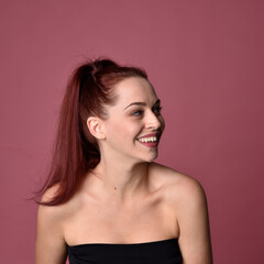 Naklejka premium close up portrait of red haired women with different facial expressions on a pink studio background.
