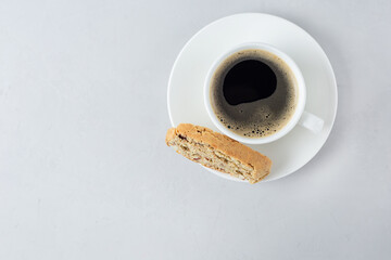 A cup of coffee with Italian biscotti cookie. Top view fresh baked cookie with white cup of coffee....