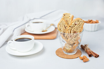Italian cranberry almond biscotti and cup of coffee on background. Selective focus