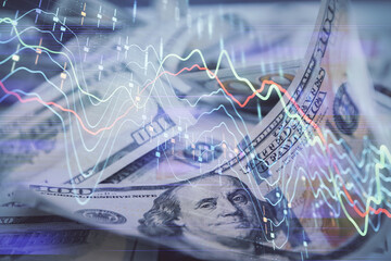 Double exposure of forex graph drawing over us dollars bill background. Concept of financial...