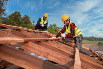 Roofer, Two roofer carpenter working on roof structure on construction site, Teamwork construction...