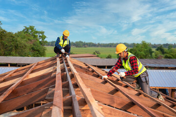 Roofer, Two worker roofer builder working on roof structure on construction site, Teamwork construction concept.