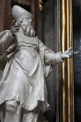 statue of an holy character or a clergyman in a baroque church (peterskirche) in vienna (austria)