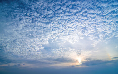 Sky background with low sun and cirrocumulus clouds