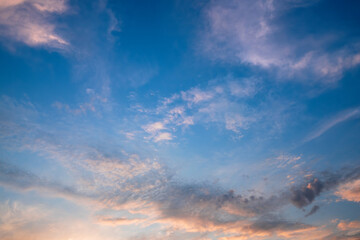 Naklejka na ściany i meble Beautiful clouds illuminated by sunrise. Sky background