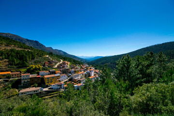 Fototapeta na wymiar Landscape of a town with mountains, forest and sky in Las Hurdes.