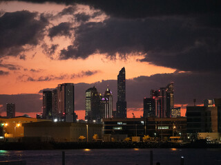 Fototapeta premium Skyline of Abu Dhabi a big city during sunset with beautiful red sky