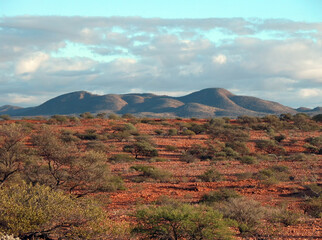 Wide shot of eroded hills, with a red rocky foreground.
Clever Mary Hills, on Mount Philips...