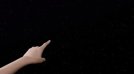 woman's hand pointing to starry sky