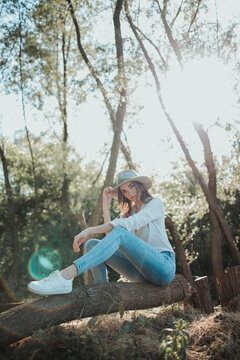 Bosnian Caucasian Woman Sitting On A Log In A Forest