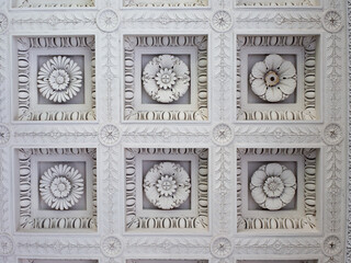 coffered ceiling made of  stucco  tessels  with floral decorations - obrazy, fototapety, plakaty