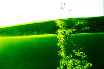 Water wave with bubble of air, on white background. Green water
