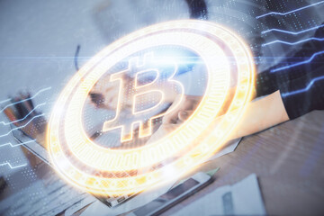 Double exposure of woman hands typing on computer and crypto market theme hologram drawing....