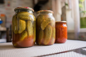 canned cucumbers in a jar on the kitchen table