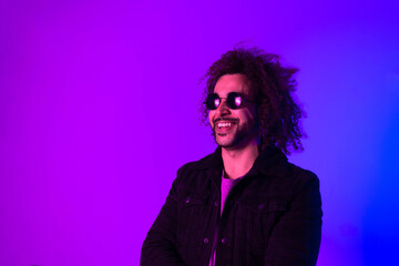 Portrait of an Afro-American hipster man, afro hair, in the style of the 80s and 90s, steampunk glasses, blue and purple neon lights. smiling and laughing