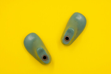 Green pad or form for making children's uniforms on a yellow background. Shoe industry